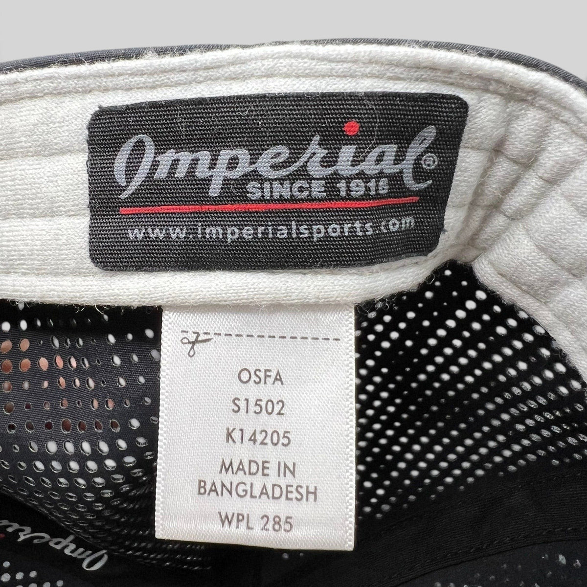 Raree Finds Imperial brand label and care tag inside a black performance snapback hat with perforated mesh panels.