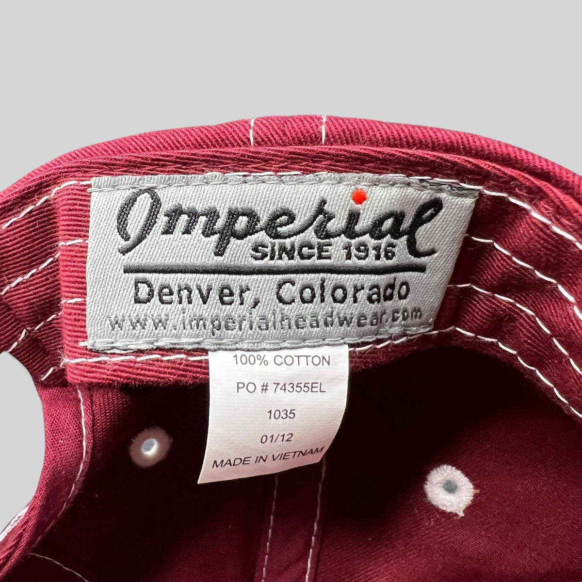 Raree Finds Imperial brand label inside a red cotton Snowmass Club strapback hat with white contrast stitching