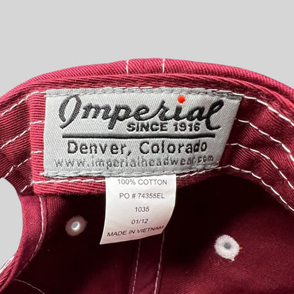 Raree Finds Imperial brand label inside a red cotton Snowmass Club strapback hat with white contrast stitching