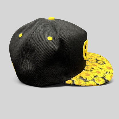 Raree Finds Insomniac EDC snapback hat with a black crown and vibrant yellow sunflower print flat brim
