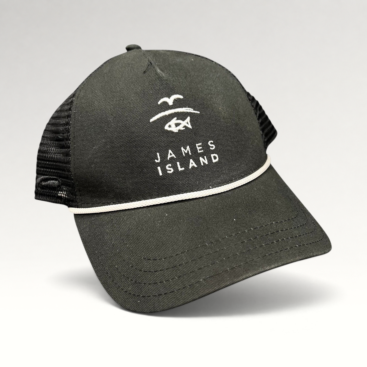 Raree Finds black trucker hat with white James Island coastal logo embroidery, mesh back, and rope detail on the brim.