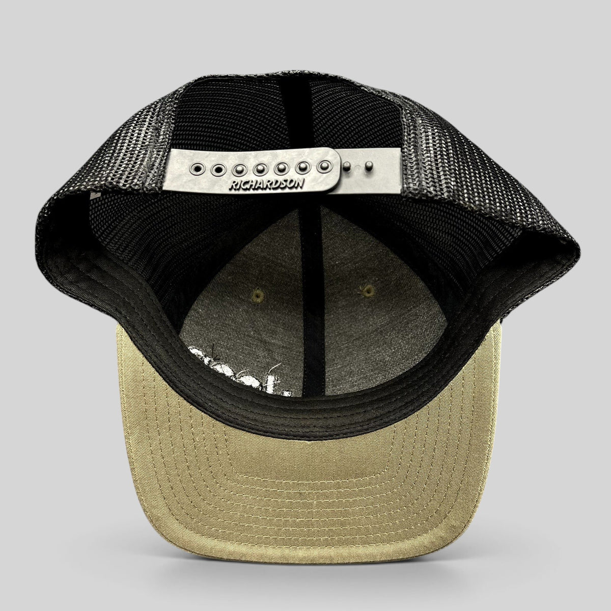 Raree Finds Jeep Punisher Richardson 112 trucker hat showing the interior, black mesh back, and olive snapback closure.