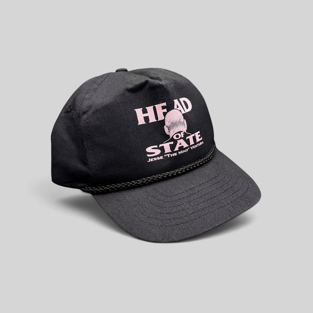 Raree Finds vintage black cotton twill snapback hat with pink Jesse Ventura Head of State graphic and rope trim.