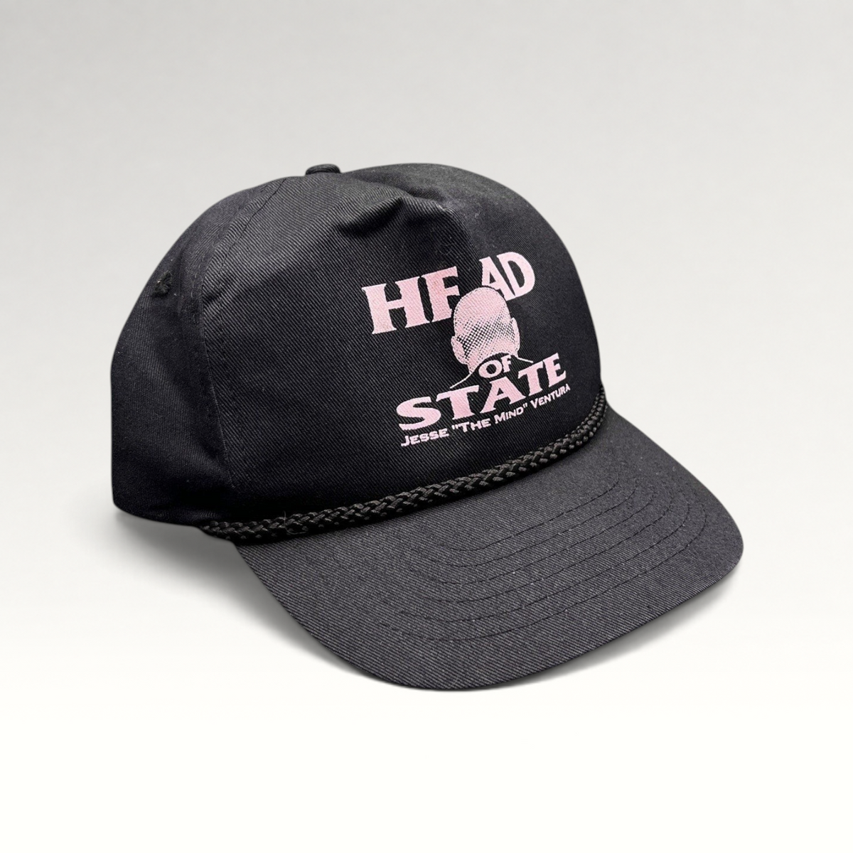 Raree Finds vintage black cotton twill snapback hat with pink Jesse Ventura Head of State graphic and rope trim.