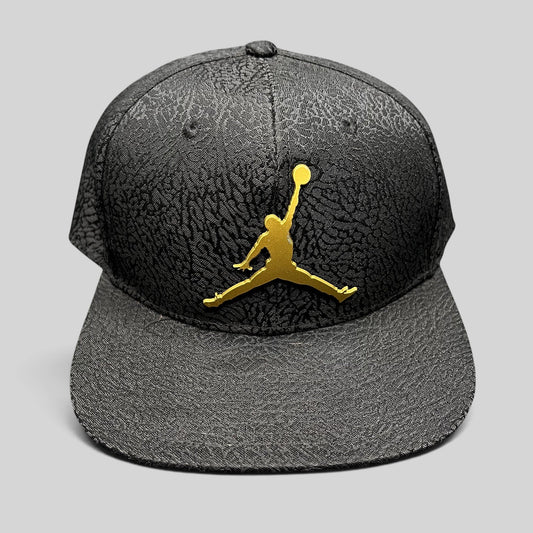 Raree Finds youth Jordan snapback hat in black with an elephant print texture and a metallic gold Jumpman logo.