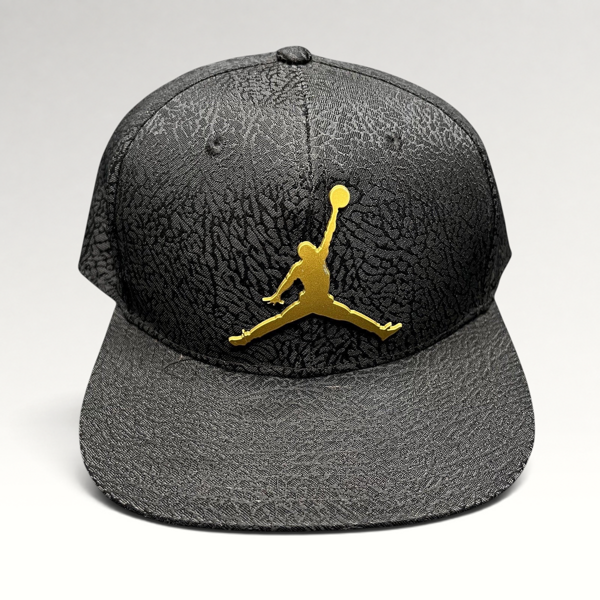 Raree Finds youth Jordan snapback hat in black with an elephant print texture and a metallic gold Jumpman logo.