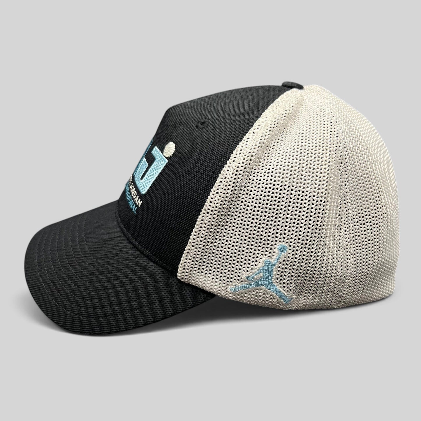 Raree Finds black and white Jordan MJ Invitational mesh back golf hat with embroidered Jumpman logo side view