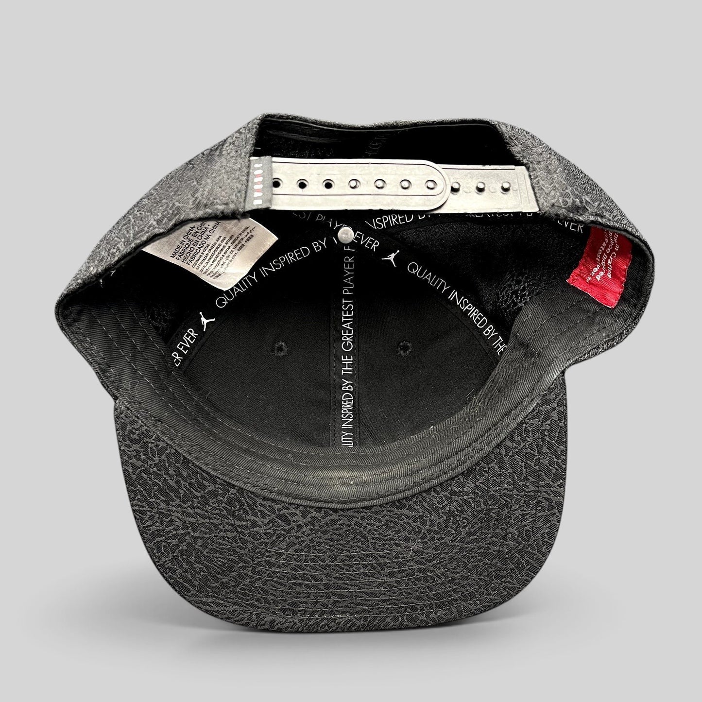 Raree Finds youth Jordan snapback hat interior view showing adjustable strap and elephant print pattern on the brim
