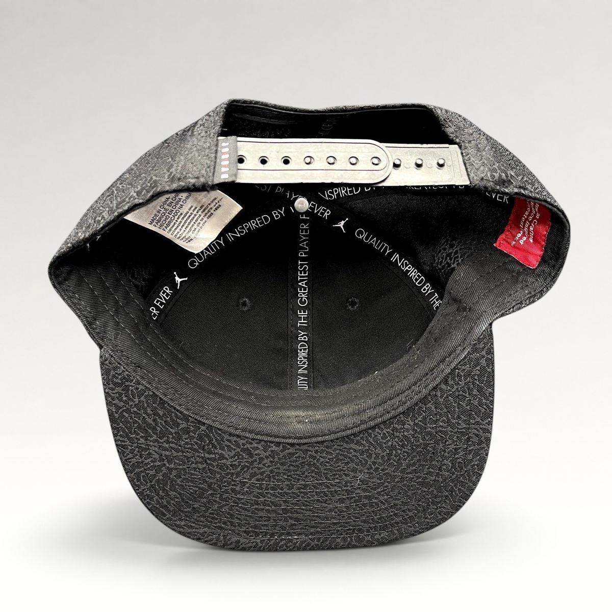 Raree Finds youth Jordan snapback hat interior view showing adjustable strap and elephant print pattern on the brim