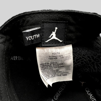 Raree Finds youth Jordan snapback interior showing the Jumpman logo tag and manufacturing label with elephant print