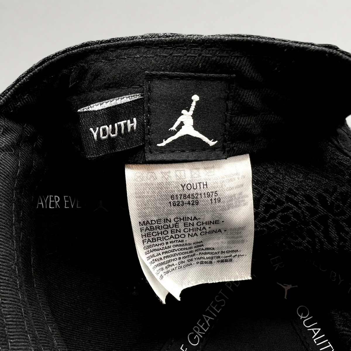 Raree Finds youth Jordan snapback interior showing the Jumpman logo tag and manufacturing label with elephant print