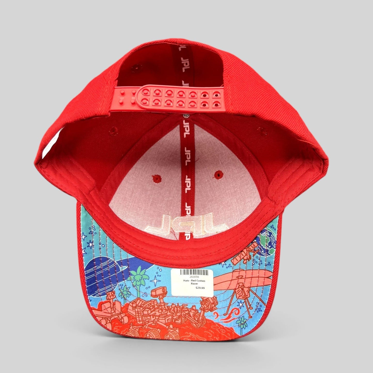 Raree Finds JPL red snapback hat with space-themed illustrated underbrim showing Mars rovers and planets