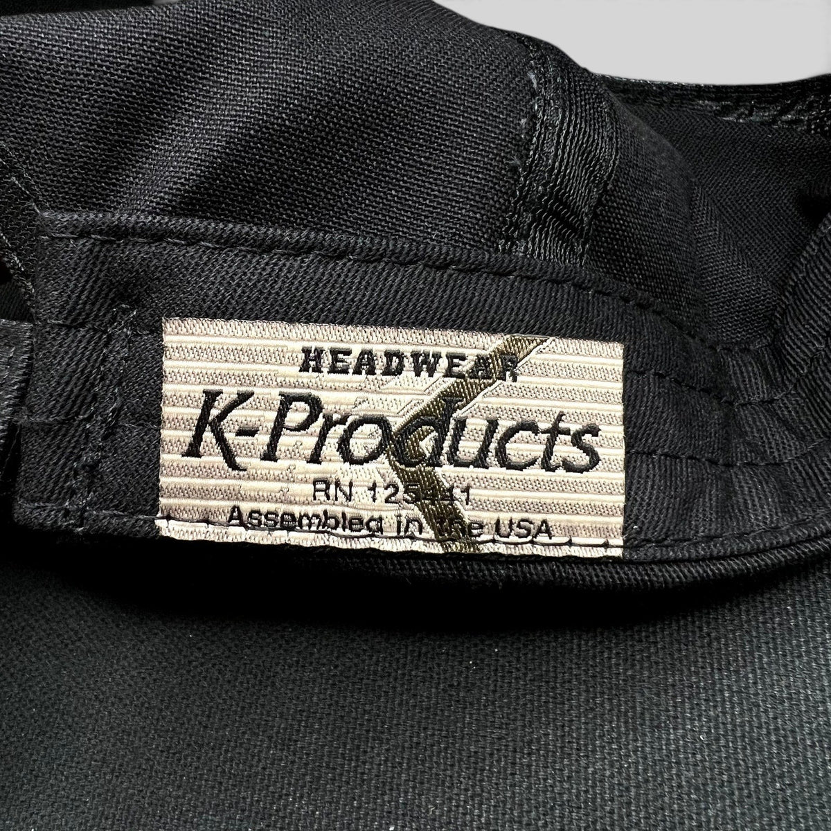 Raree Finds vintage K-Products hat interior label showing Headwear branding and Assembled in the USA text