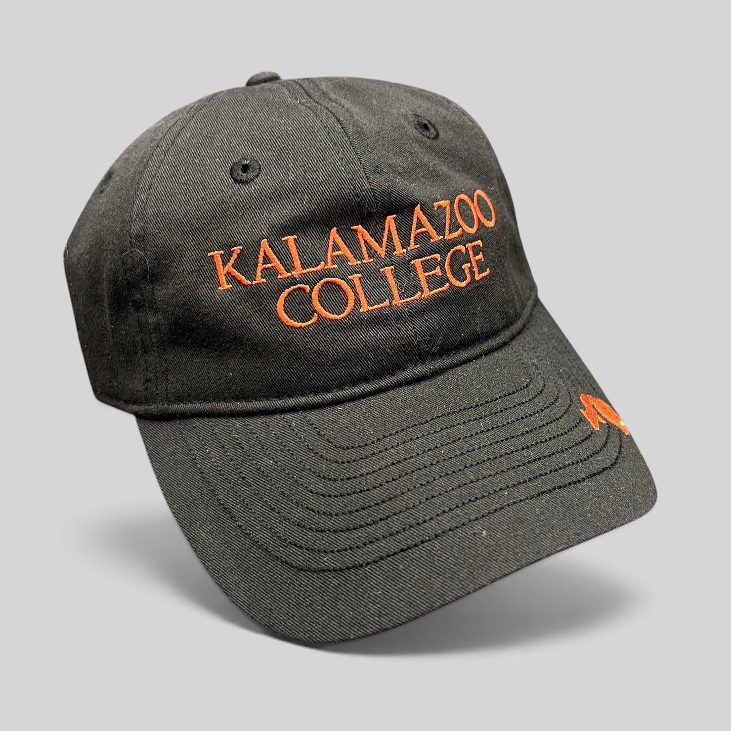 Raree Finds black cotton twill Kalamazoo College dad cap with orange embroidered lettering and brim accent