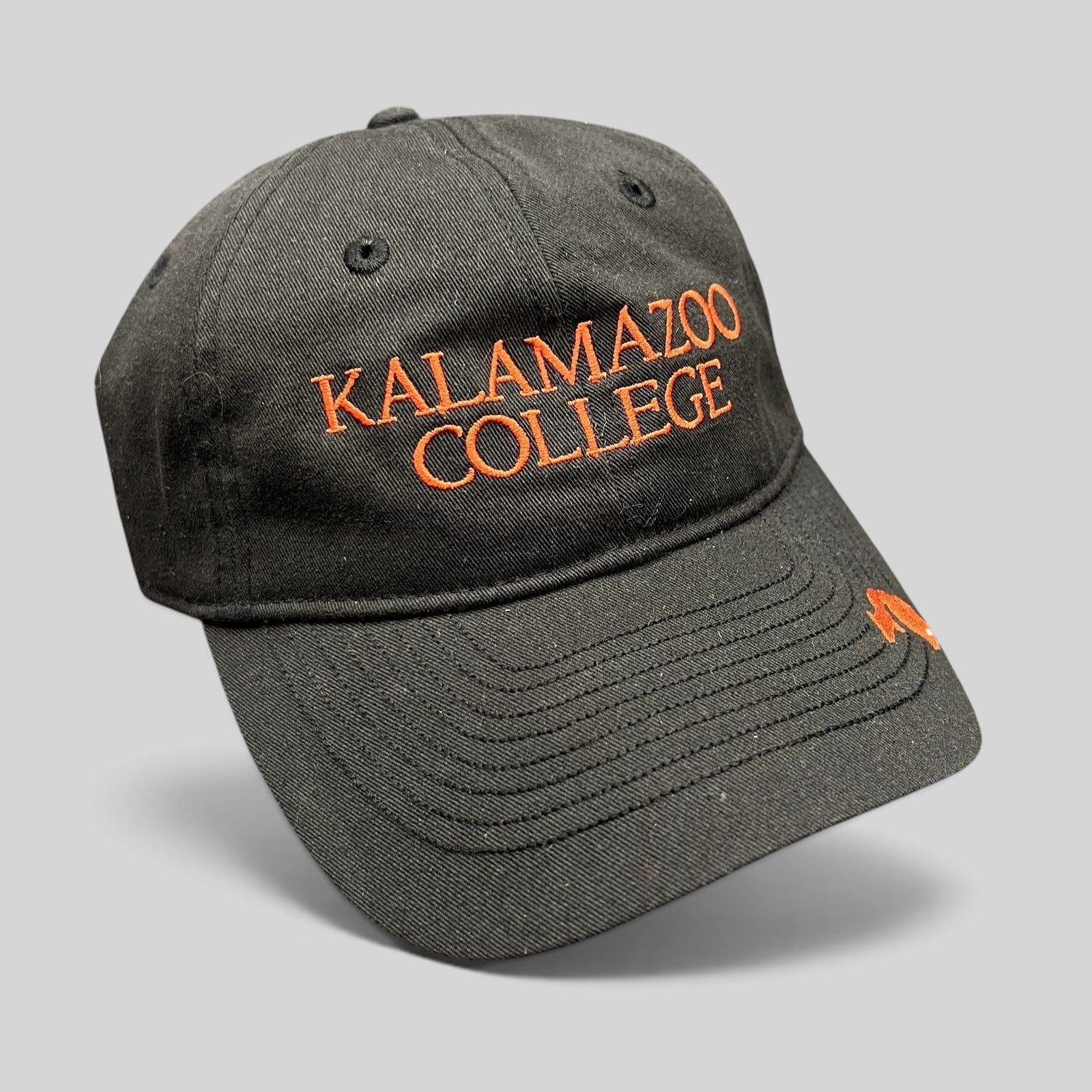 Raree Finds black cotton twill Kalamazoo College dad cap with orange embroidered lettering and brim accent