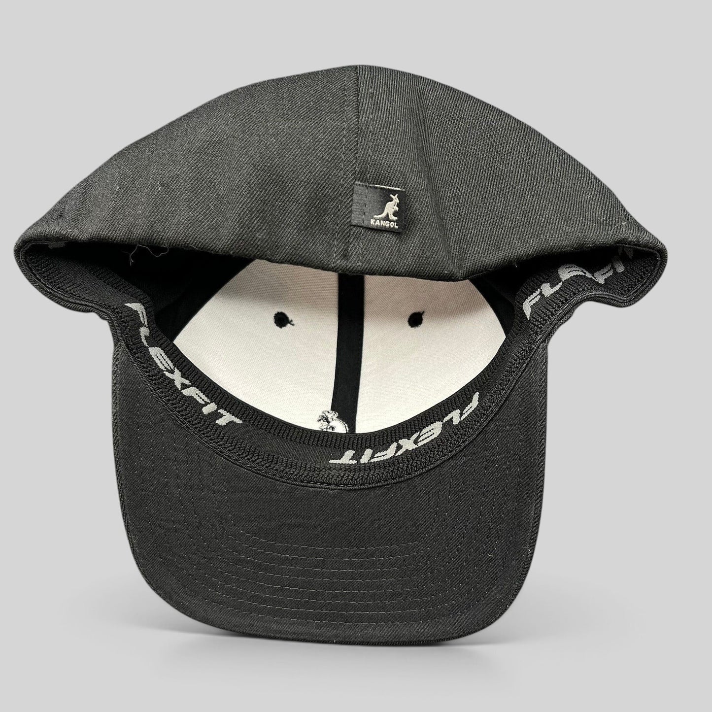 Raree Finds Kangol black flexfit baseball cap with white embroidered kangaroo logo and interior stretch band