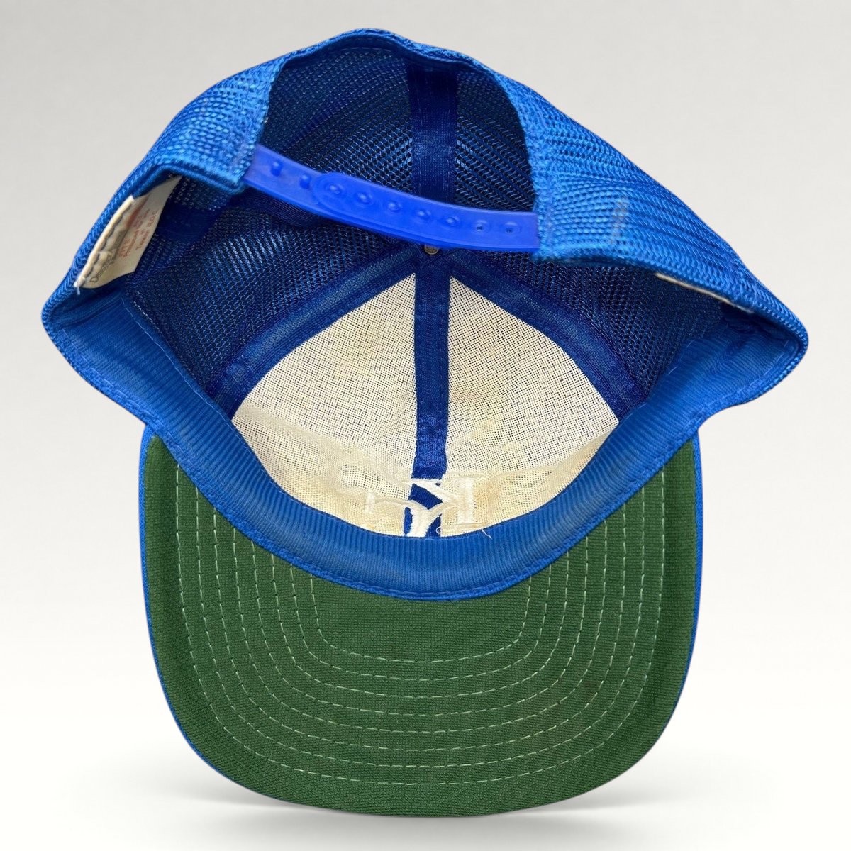 Raree Finds vintage Kansas City Royals trucker hat interior view showing green undervisor and blue mesh back