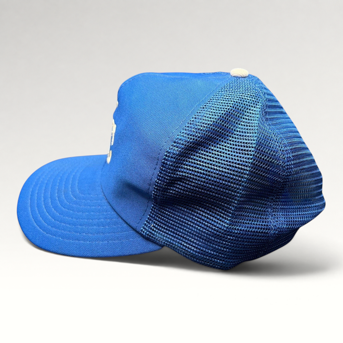 Raree Finds vintage Kansas City Royals trucker hat in royal blue with mesh back and foam front side profile view