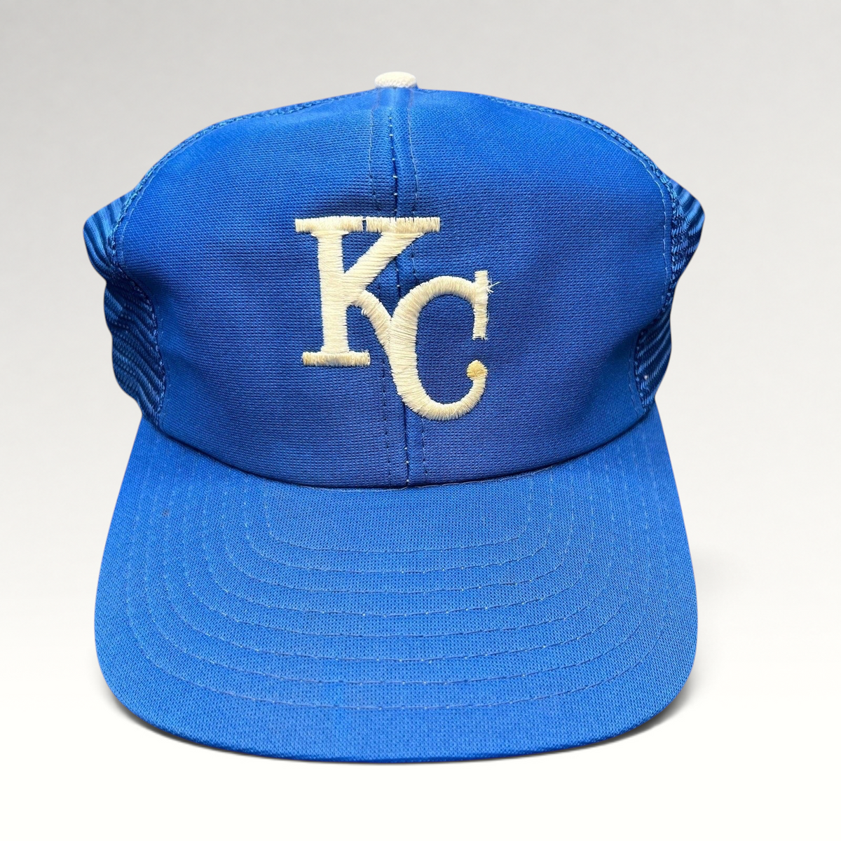 Raree Finds vintage Kansas City Royals trucker hat with royal blue foam front, off-white KC logo, and mesh back.