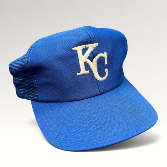 Raree Finds vintage Kansas City Royals trucker hat with royal blue foam front, mesh back, and off-white KC embroidery.