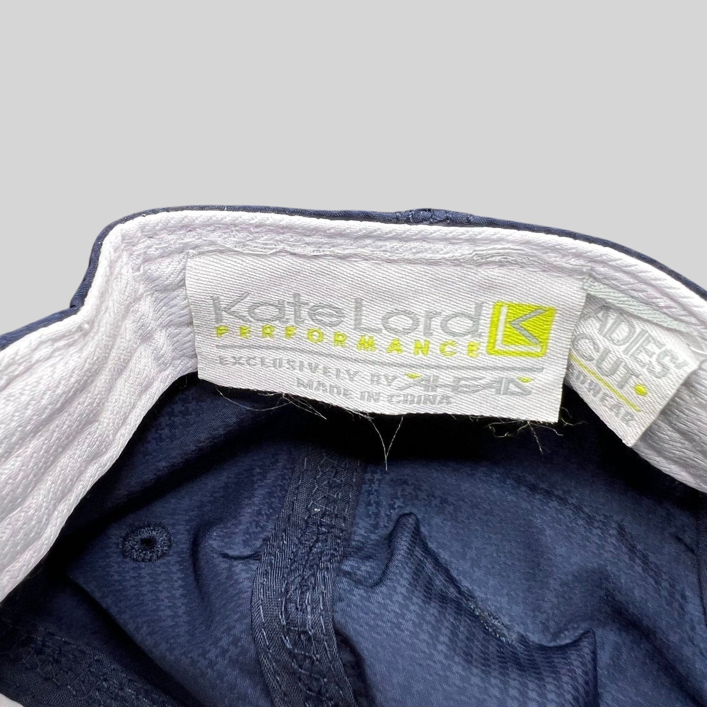 Raree Finds navy Kate Lord Performance cap interior label showing brand branding and ladies cut tag