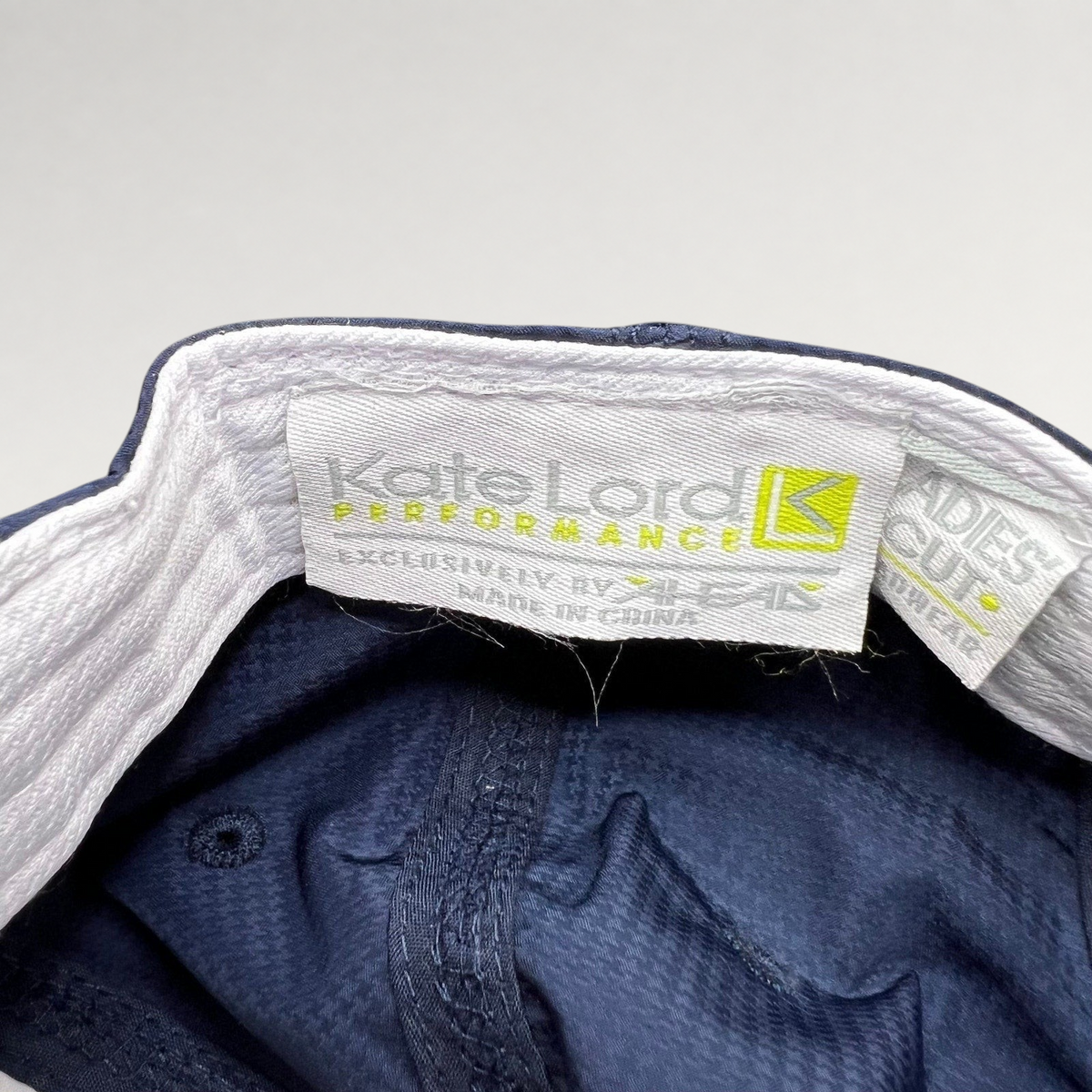 Raree Finds navy Kate Lord Performance cap interior label showing brand branding and ladies cut tag