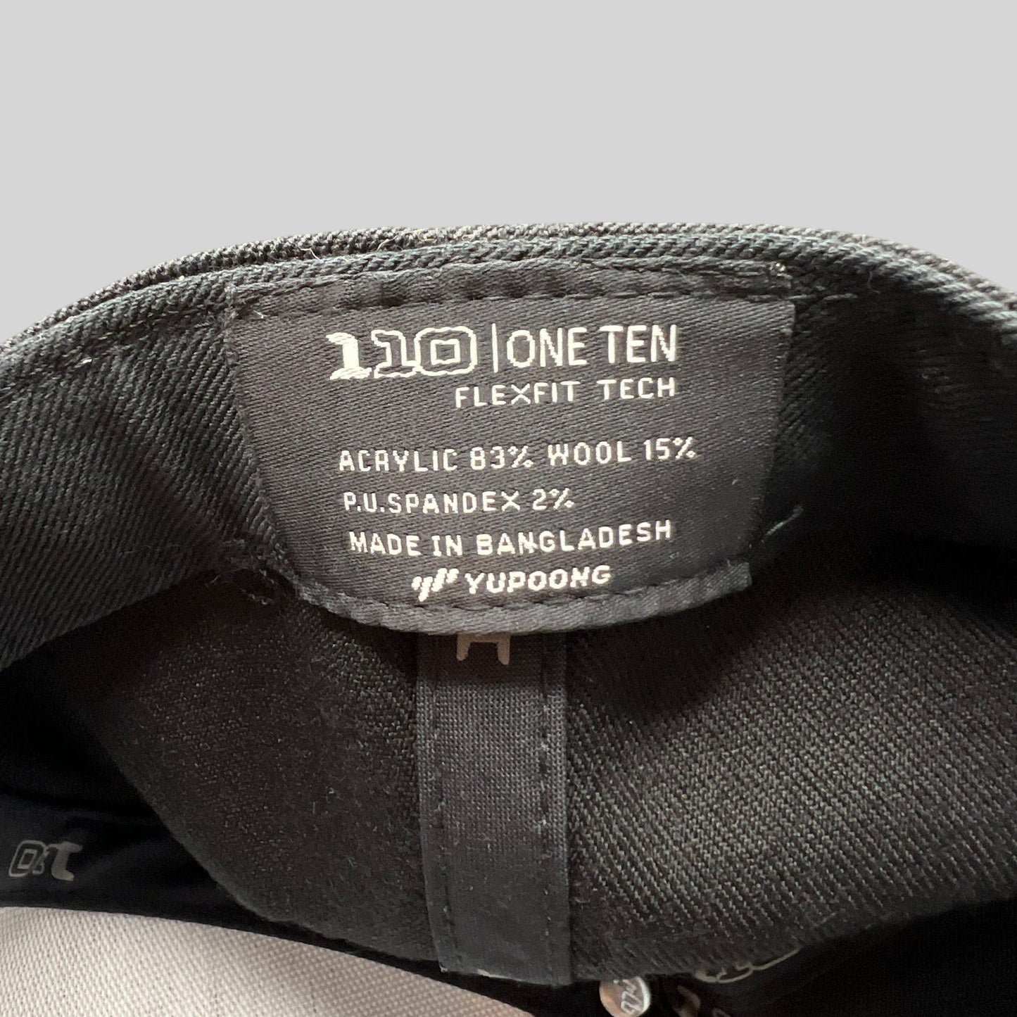 Raree Finds Kenichi Fishing hat interior tag showing Yupoong Flexfit 110 technology and material composition