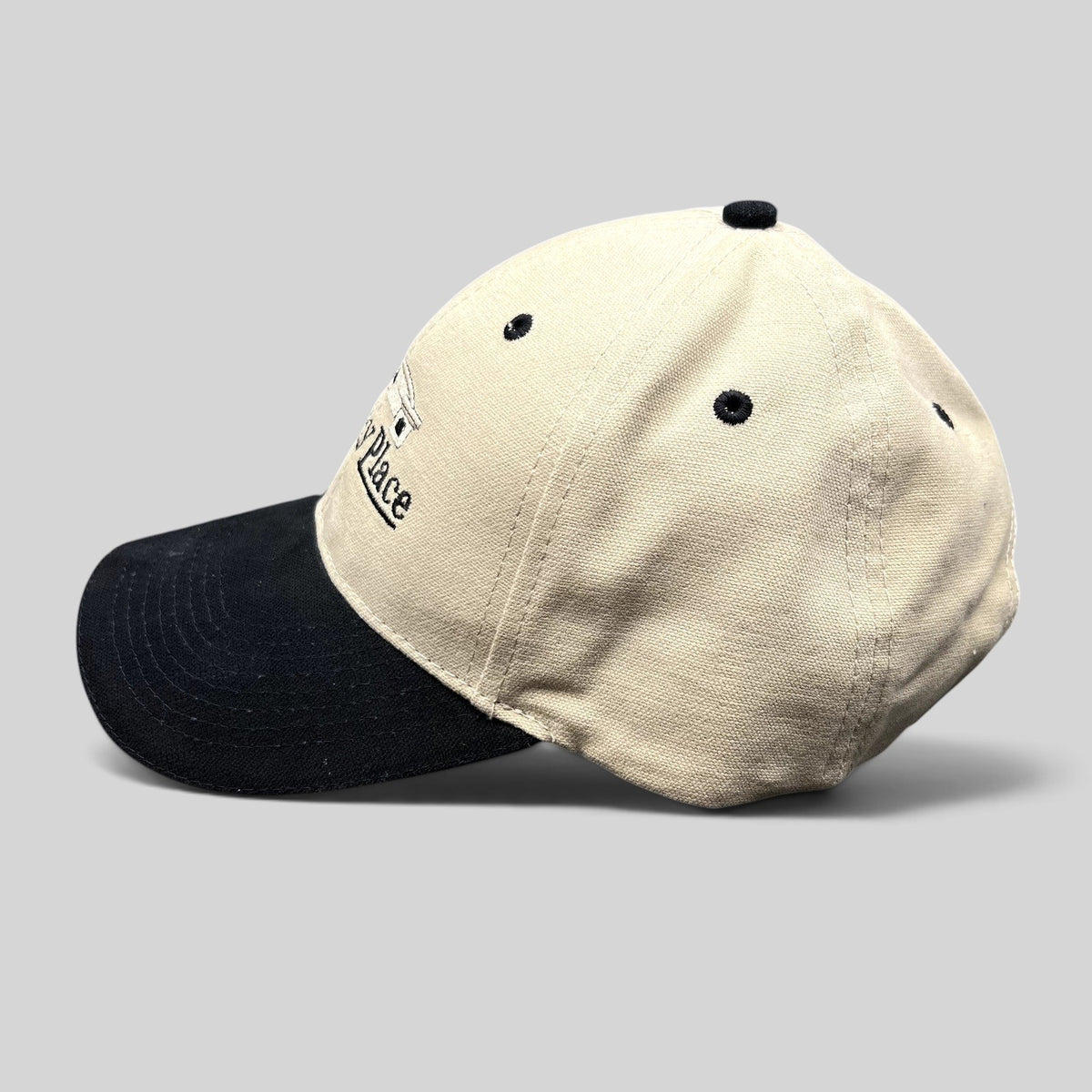Raree Finds two-tone khaki and black cotton dad hat with embroidered Tourney Place clubhouse logo and curved brim