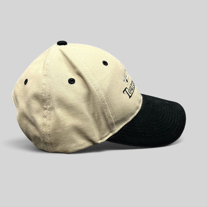 Raree Finds two-tone khaki and black cotton strapback dad hat with embroidered Tourney Place golf clubhouse logo