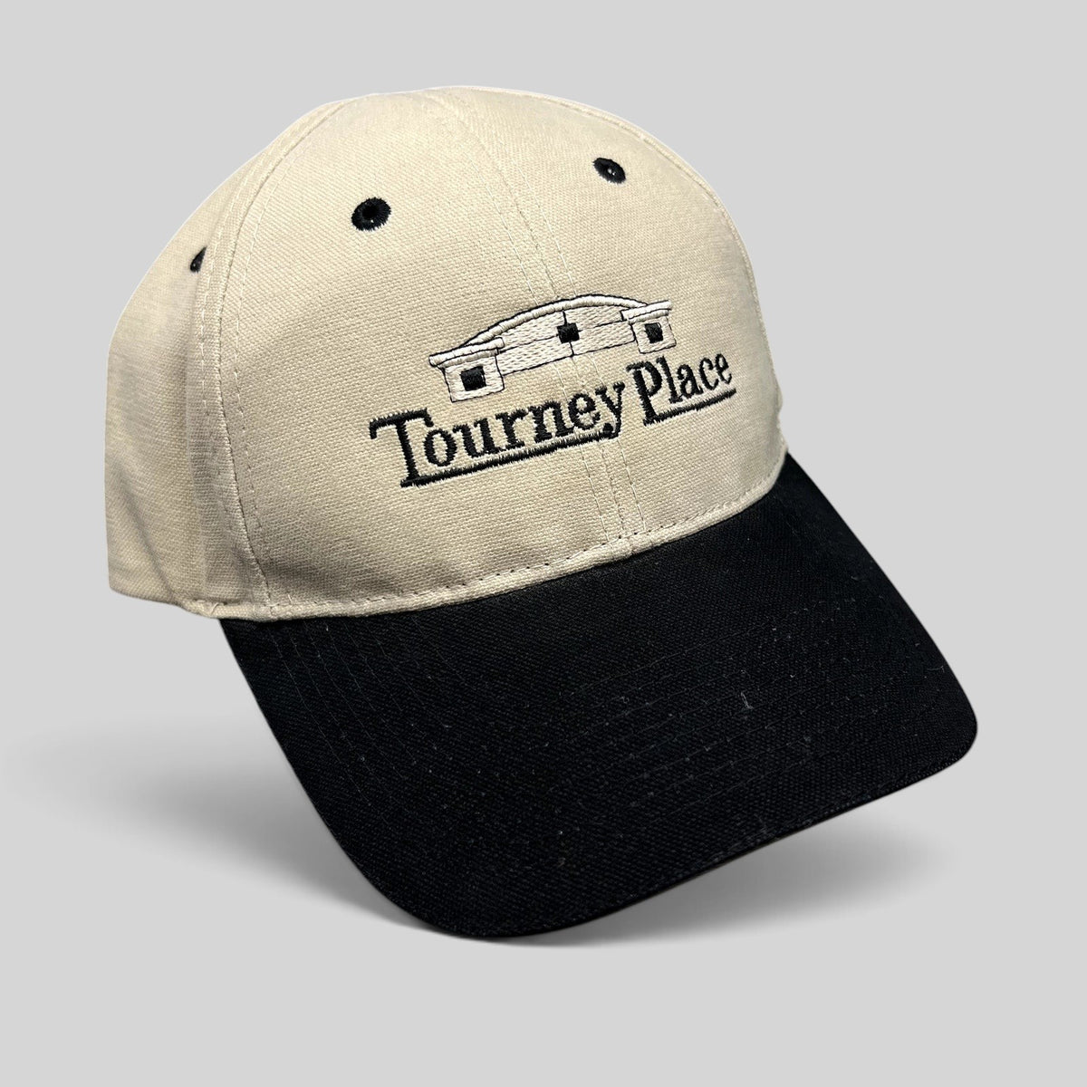 Raree Finds two-tone khaki and black cotton dad hat with embroidered Tourney Place clubhouse logo and curved brim.