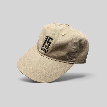 Raree Finds khaki garment-washed cotton dad hat with embroidered 15 Years festival graphic and curved brim
