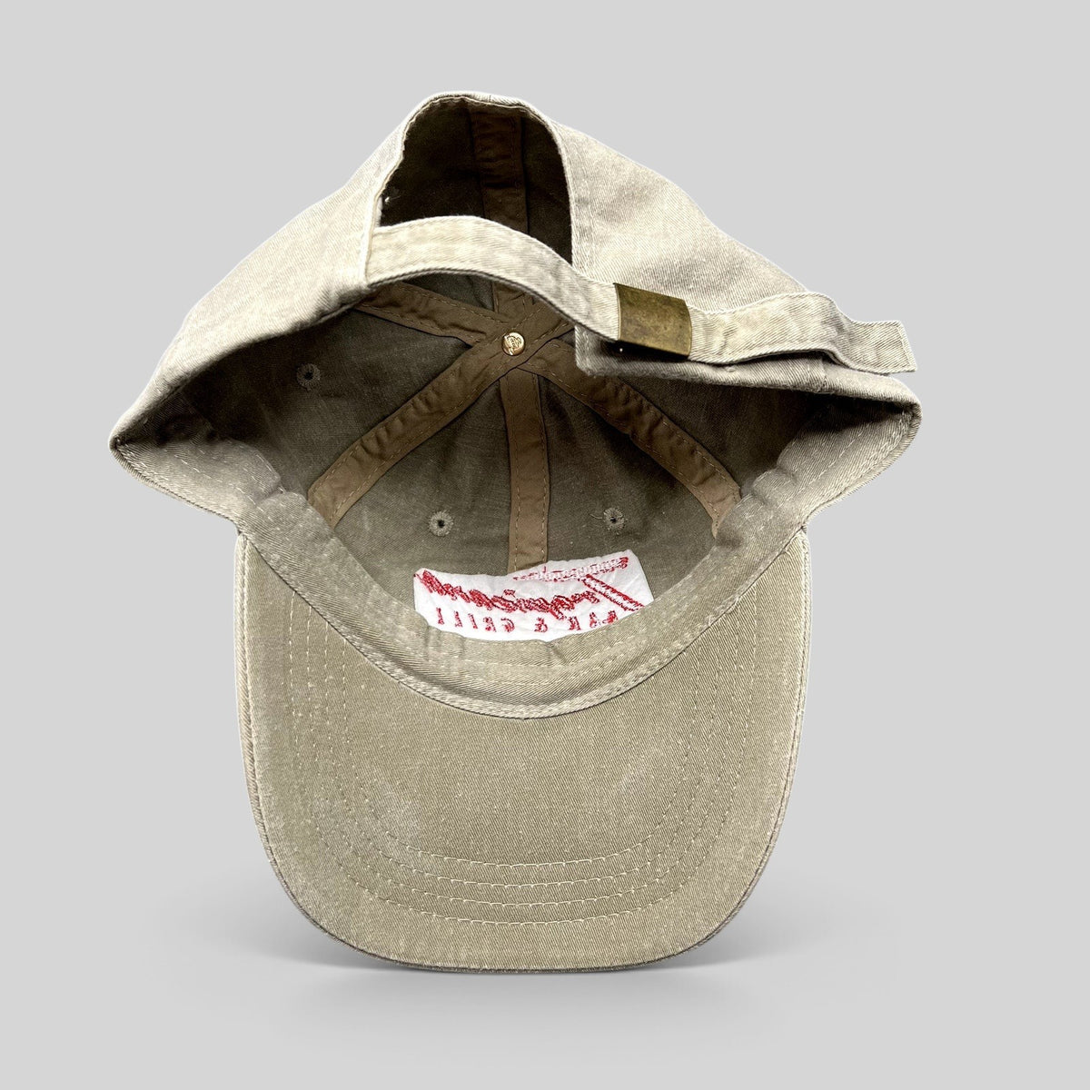 Raree Finds vintage khaki cotton OTTO strapback hat with brass buckle closure, interior view showing branding.
