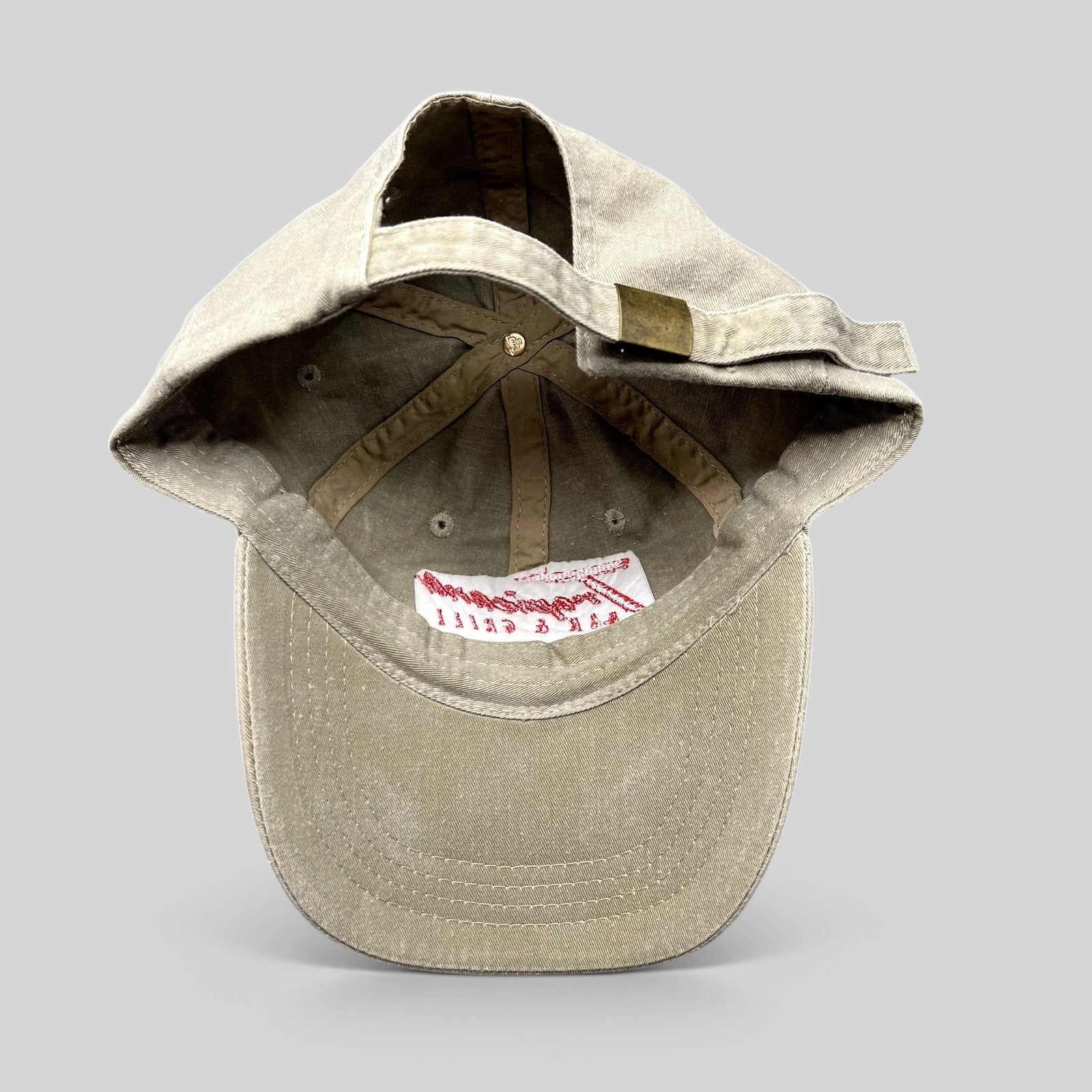 Raree Finds vintage khaki cotton OTTO strapback hat with brass buckle closure, interior view showing branding.