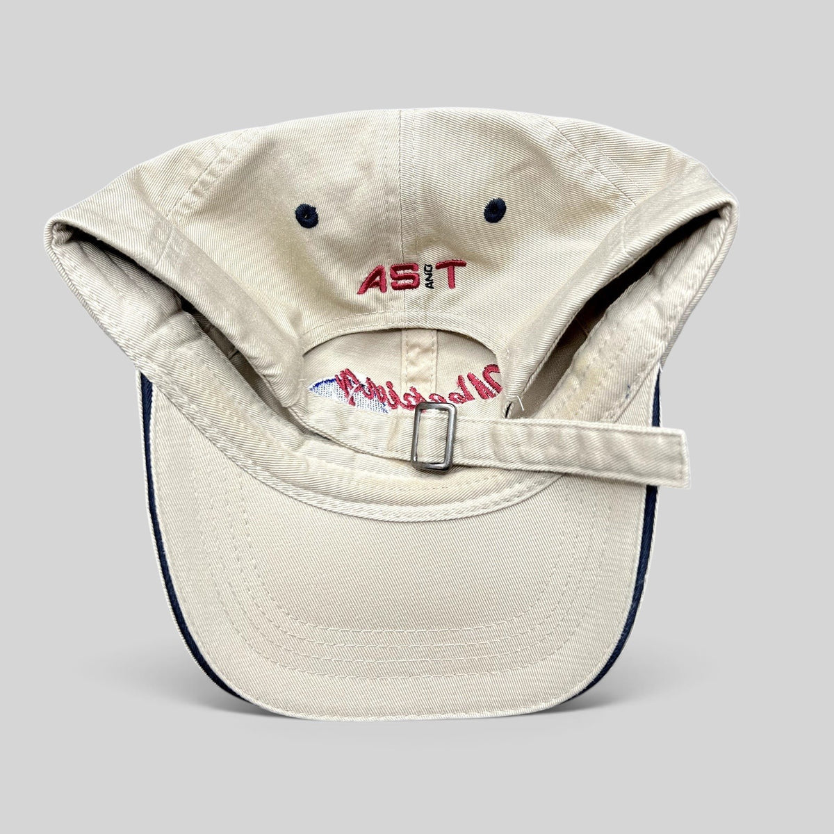 Raree Finds vintage khaki cotton strapback hat with AS&T embroidery on the back and adjustable metal buckle closure.