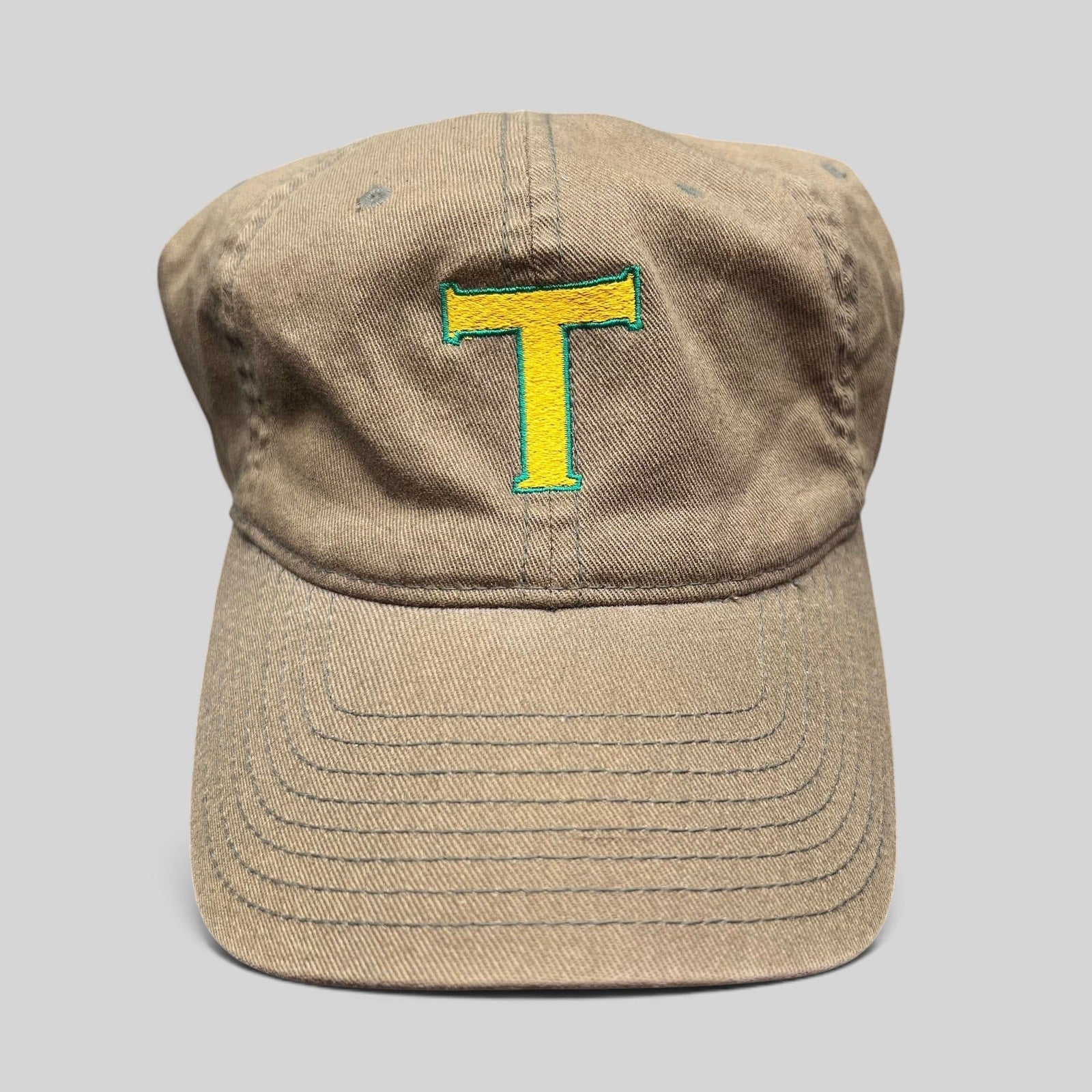 Raree Finds vintage khaki cotton twill Flexfit cap with a yellow and green embroidered T logo on the front