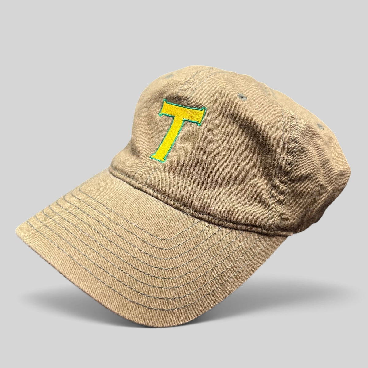 Raree Finds khaki cotton twill Flexfit hat with a yellow and green embroidered T logo on the front