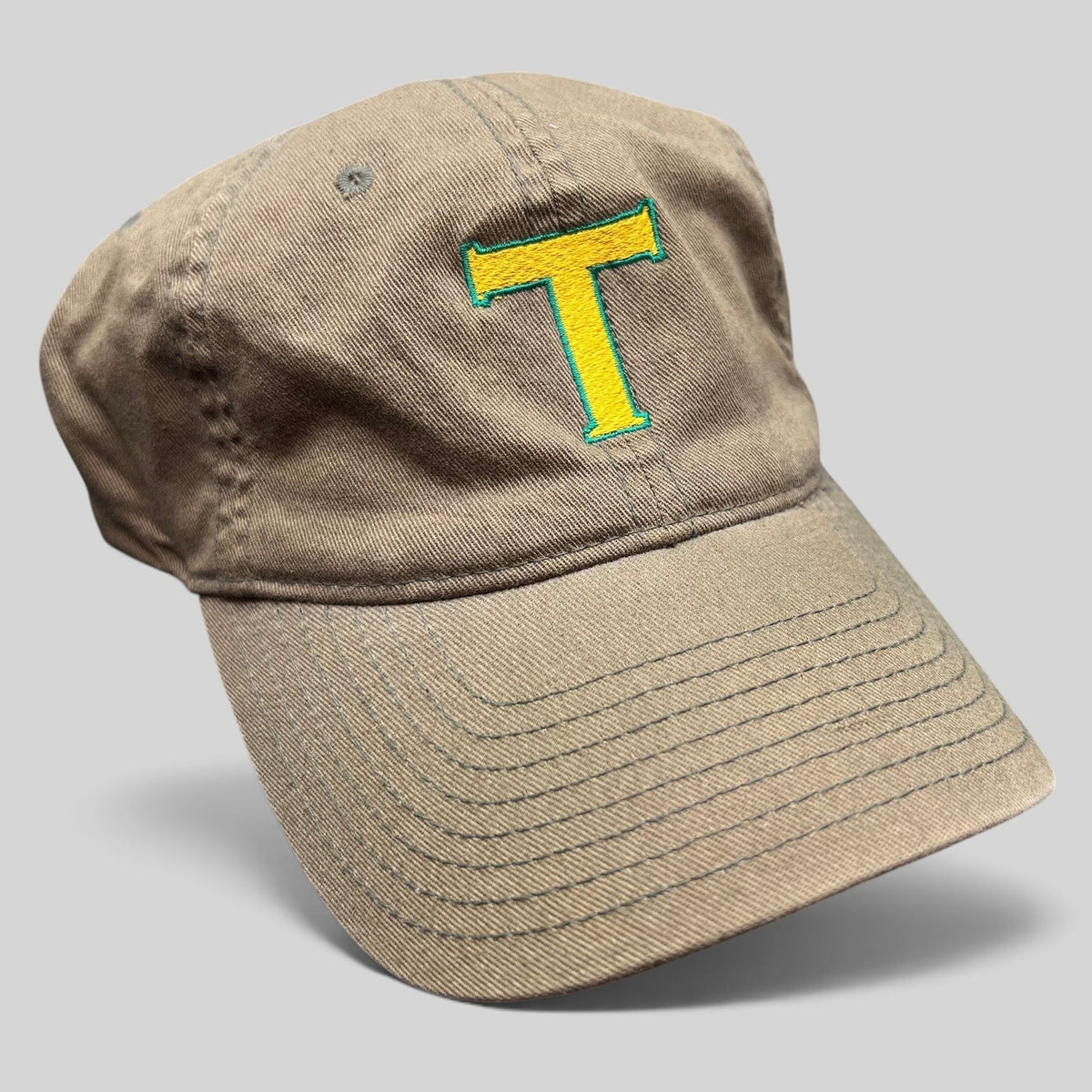 Raree Finds khaki cotton twill Flexfit hat with a yellow and green embroidered T logo on the front