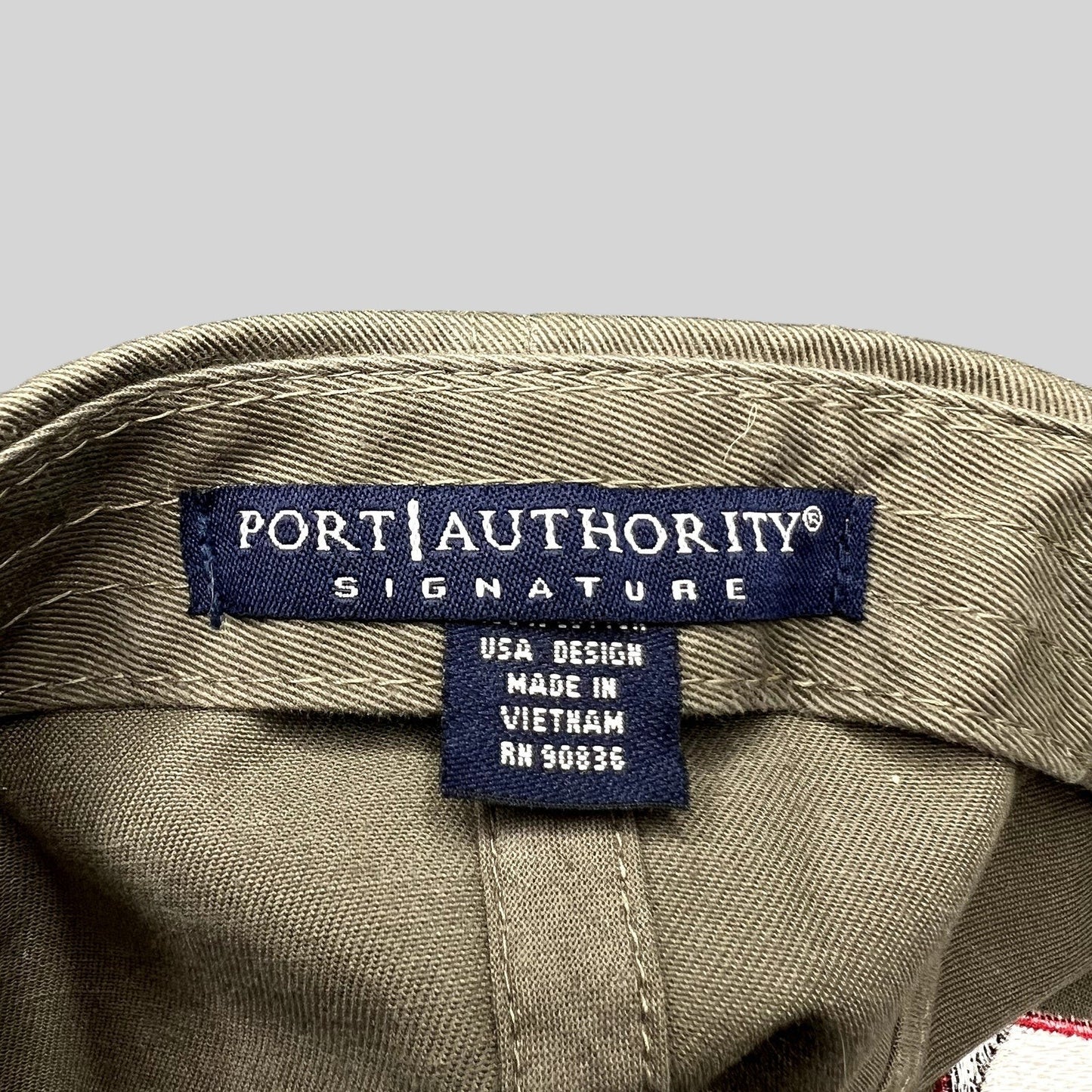 Raree Finds khaki cotton twill hat interior showing the Port Authority Signature brand label and origin tag