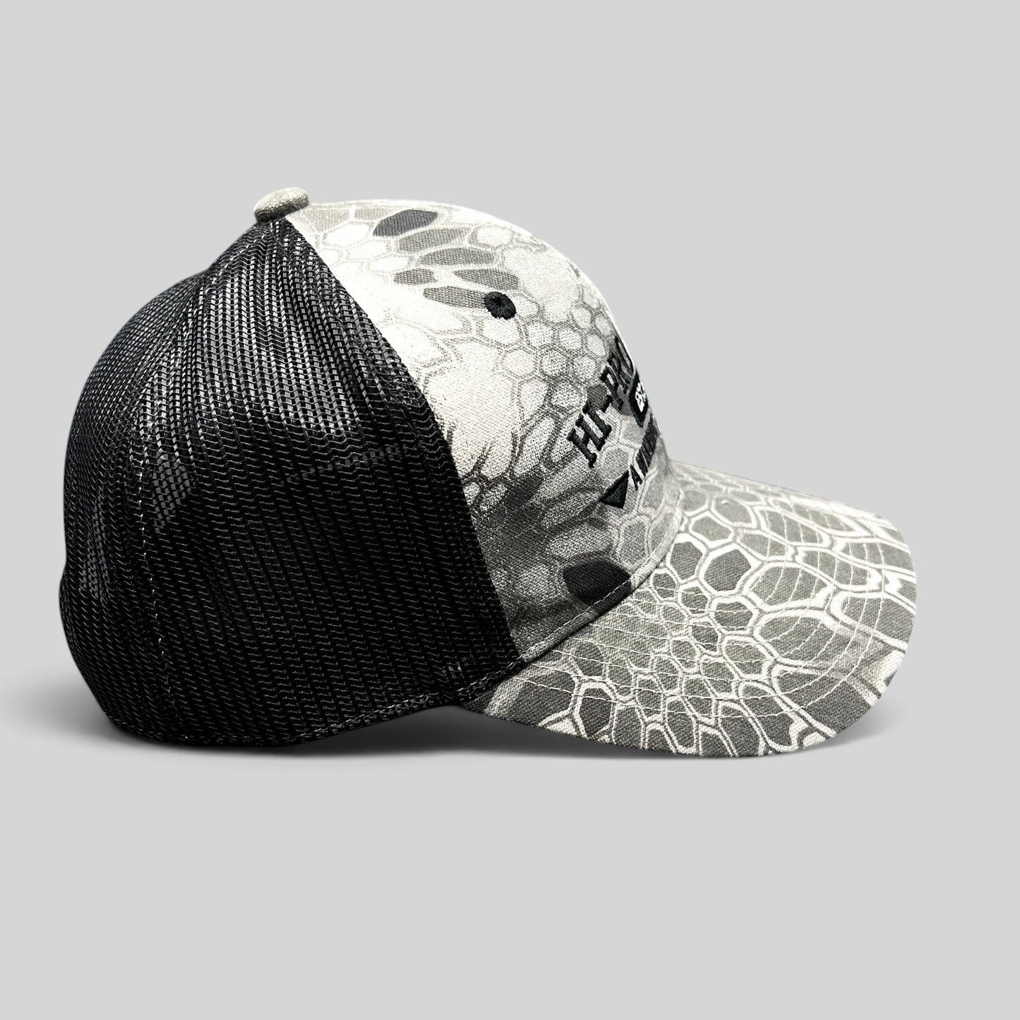 Raree Finds Hi-Pro Feeds trucker hat in gray and black Kryptek Raid camo with black mesh back and snapback closure.