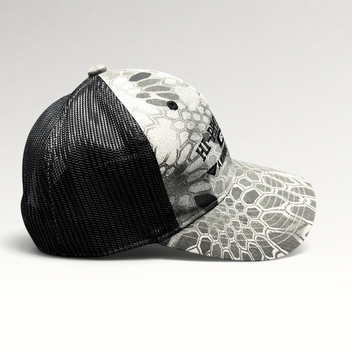 Raree Finds Hi-Pro Feeds trucker hat in gray and black Kryptek Raid camo with black mesh back and snapback closure.