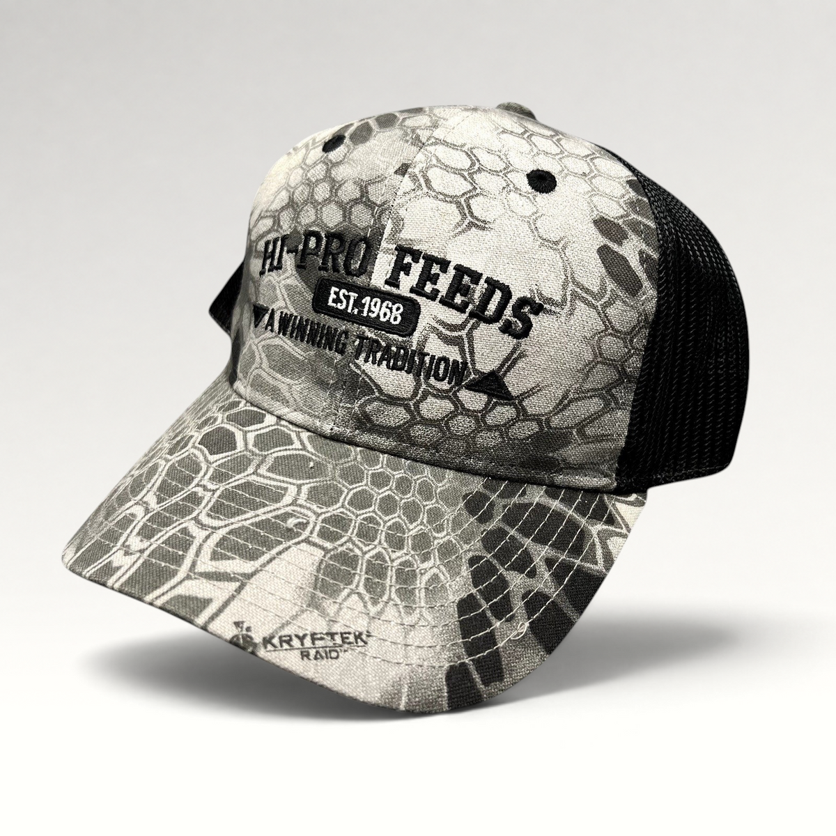 Raree Finds Hi-Pro Feeds trucker hat in gray and black Kryptek Raid camo with black embroidered logo and mesh back.
