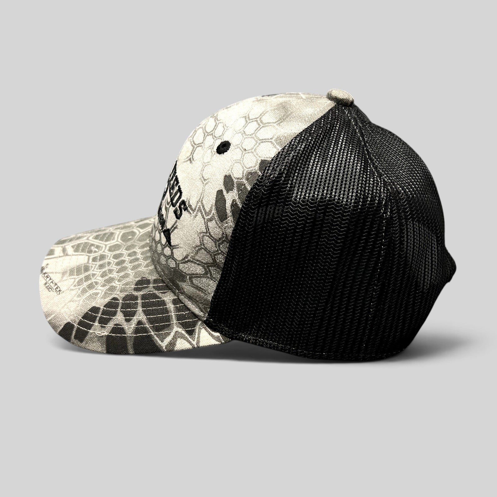 Raree Finds Hi-Pro Feeds trucker hat in gray and black Kryptek Raid camo with mesh back and embroidered logo