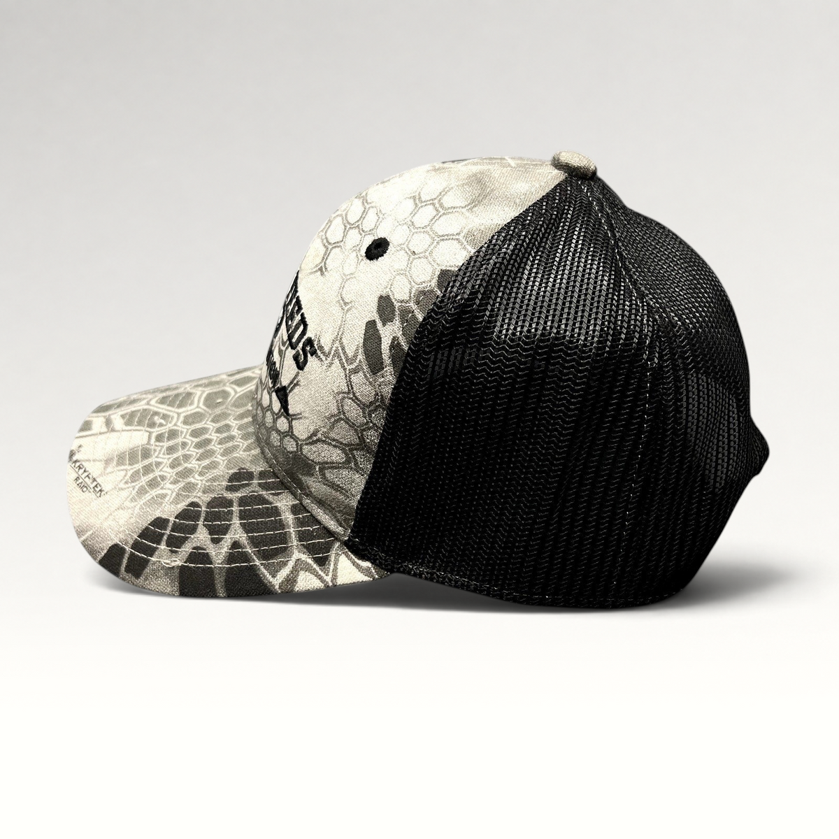 Raree Finds Hi-Pro Feeds trucker hat in gray and black Kryptek Raid camo with mesh back and embroidered logo