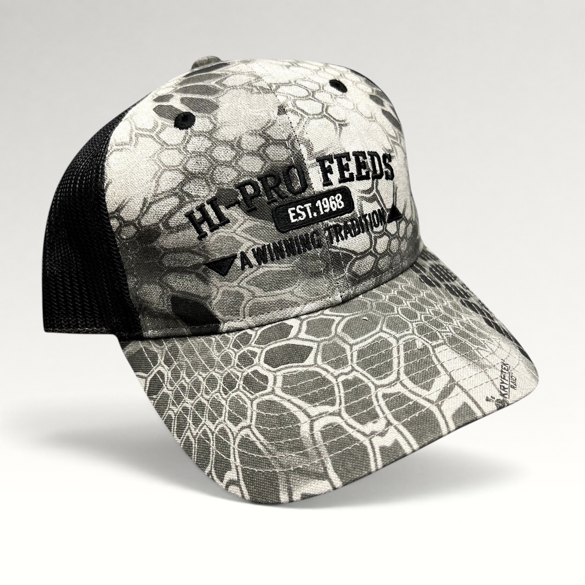 Raree Finds Hi-Pro Feeds trucker hat in gray and black Kryptek Raid camo with black mesh back and embroidered logo.