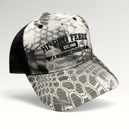 Raree Finds Hi-Pro Feeds trucker hat in gray and black Kryptek Raid camo with black mesh back and embroidered logo.