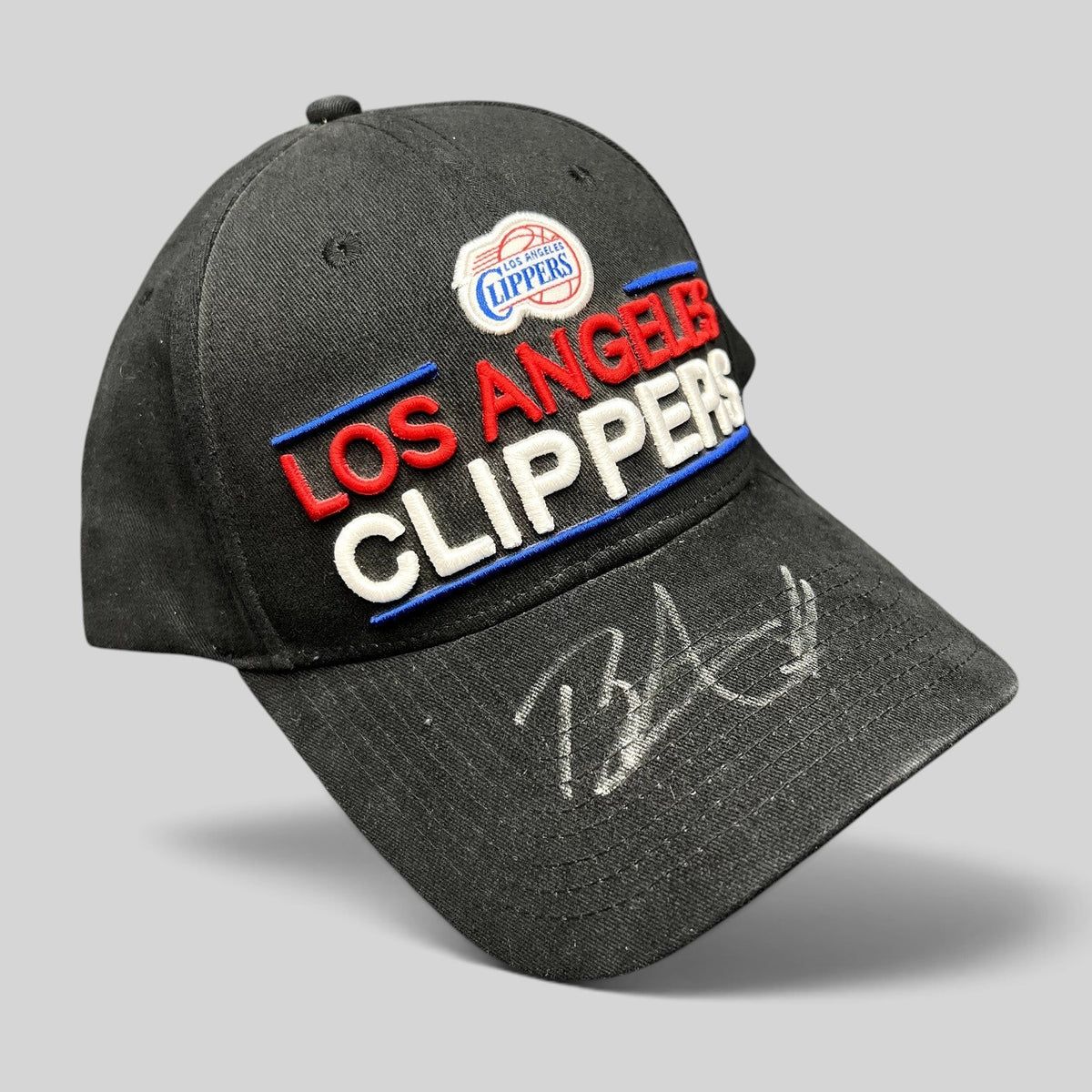 Raree Finds vintage LA Clippers strapback hat in black cotton with embroidered team logo and unidentified autograph.