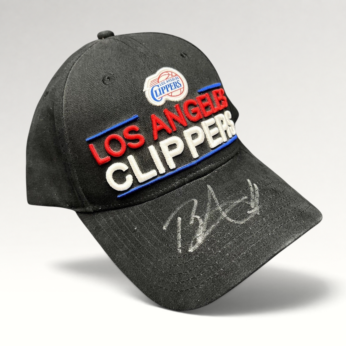 Raree Finds vintage LA Clippers strapback hat in black cotton with embroidered team logo and unidentified autograph.