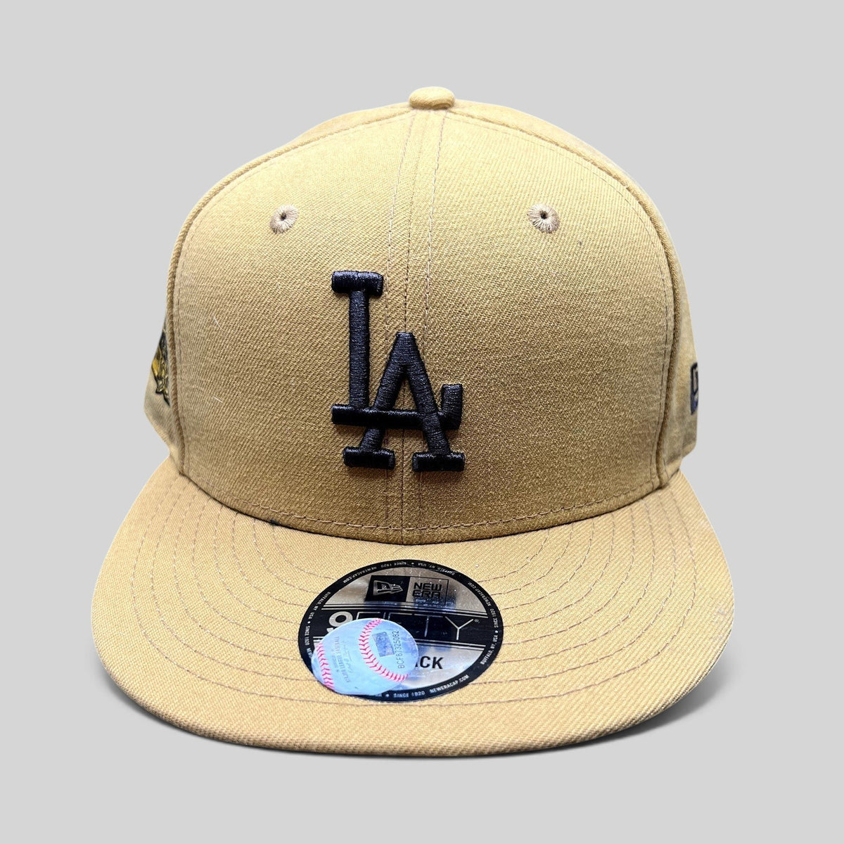 Raree Finds New Era LA Dodgers 1981 World Series 9FIFTY snapback hat in tan with a black LA logo and flat brim.