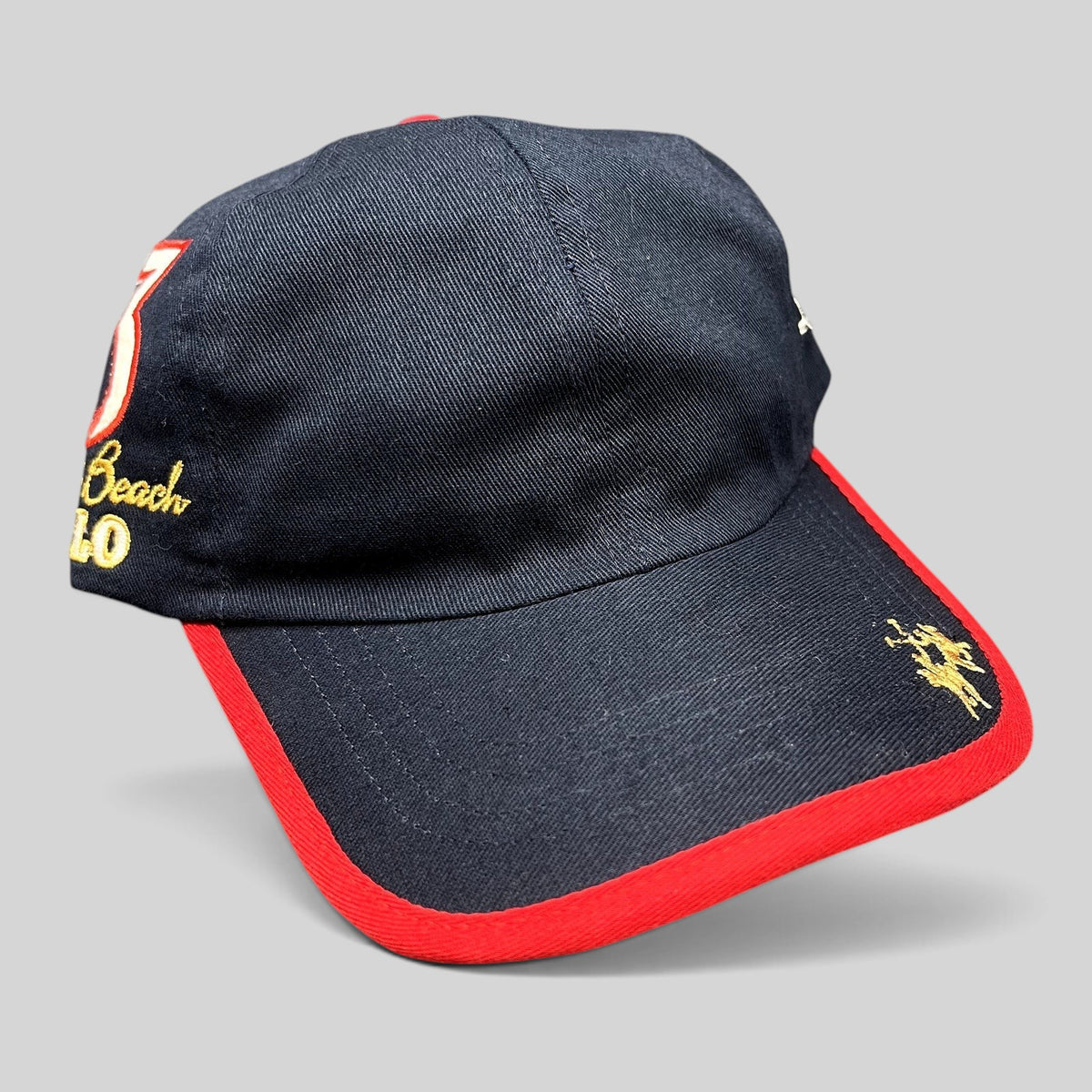 Raree Finds vintage La Martina navy blue cotton strapback hat with red brim piping and Miami Beach Polo embroidery.