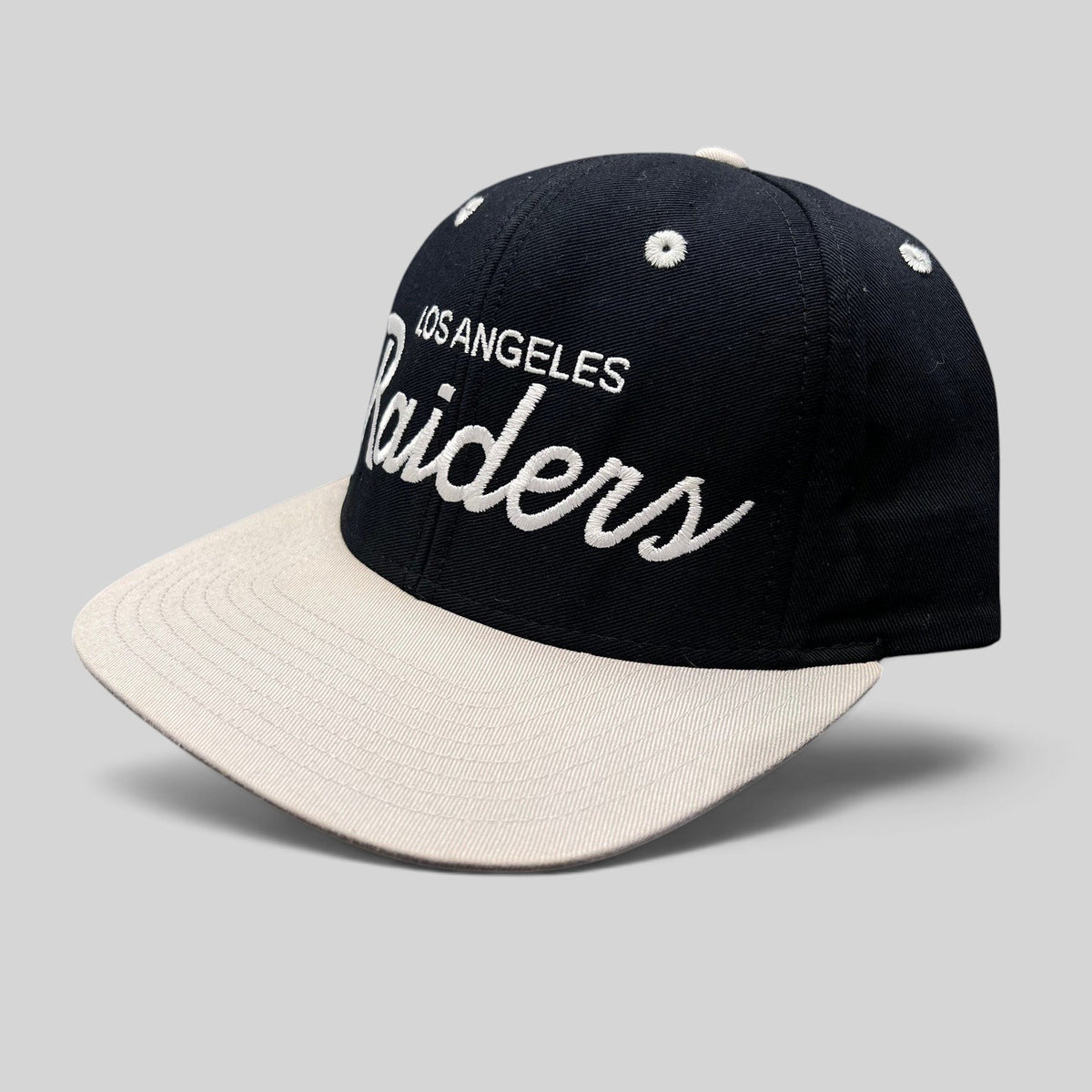Raree Finds Reebok NFL Vintage Collection LA Raiders snapback hat with black crown, grey brim, and white script logo.